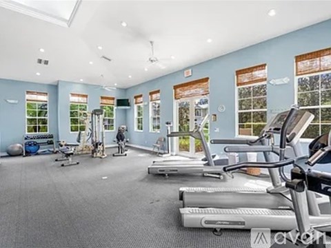A gym with treadmills, exercise bikes, and other equipment.