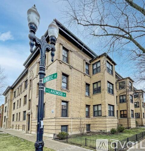 A street lamp stands in front of a brick building with the street name Morse and Lakewood.