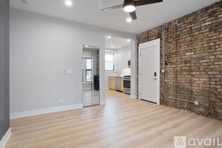 A room with a brick wall and wooden flooring.
