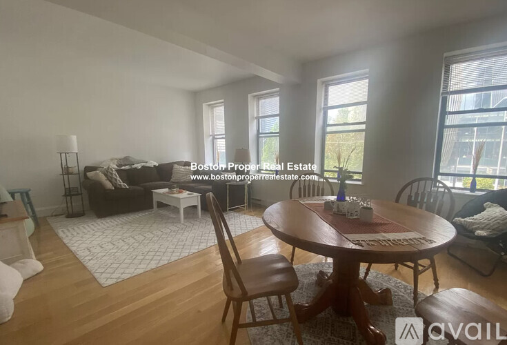 A living room with a couch, a table, and chairs.