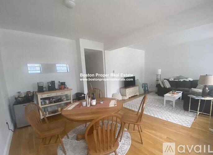 A dining room with a wooden table and chairs.