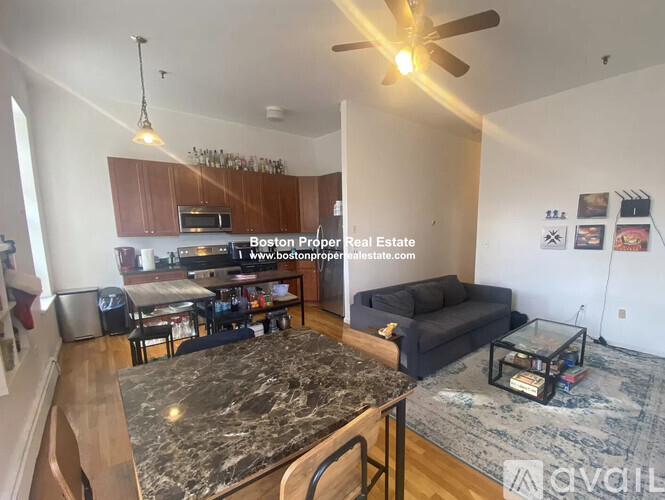 A kitchen with a marble countertop and a ceiling fan.