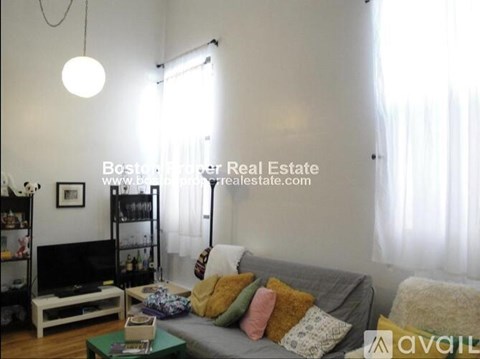 A living room with a grey couch and a coffee table.