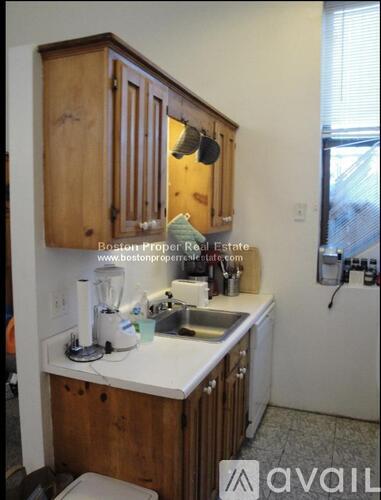 A kitchen with wooden cabinets and a white countertop.