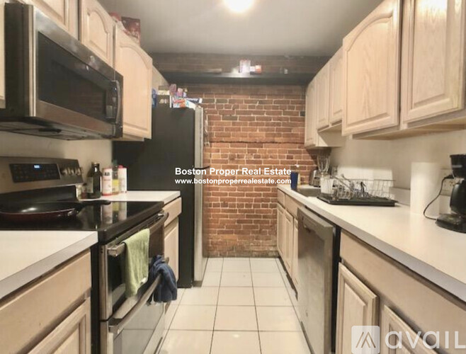 A kitchen with a brick wall in the background.