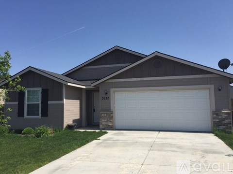 A house with a garage door and a driveway.