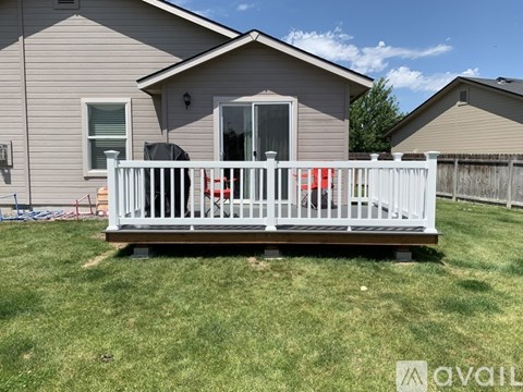 A house with a white fence and a small porch.