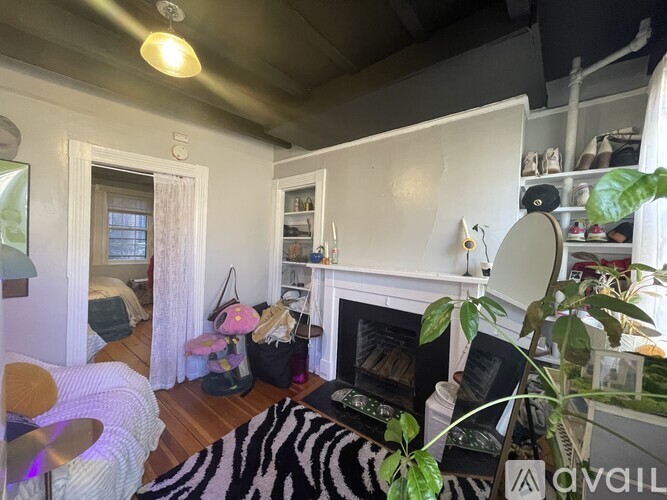 A living room with a zebra rug and a fireplace.