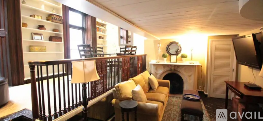A living room with a fireplace and a television.
