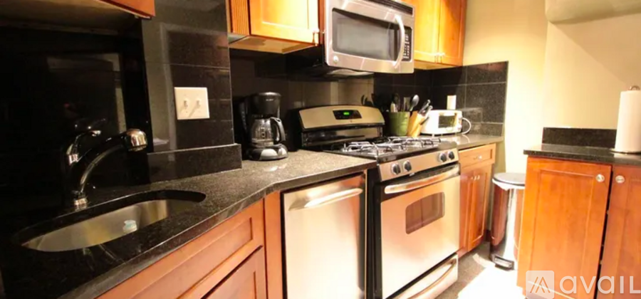 A kitchen with a stove top oven and a microwave above it.