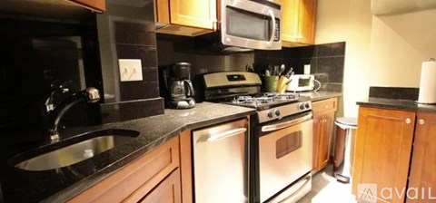 A kitchen with a stove top oven and a microwave above it.
