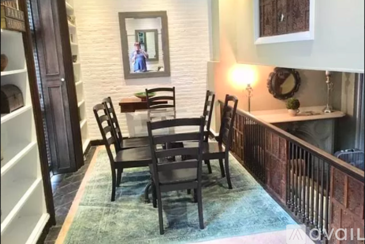 A dining room with a table and chairs.
