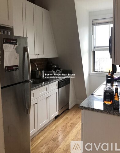 A kitchen with a refrigerator and a sink.