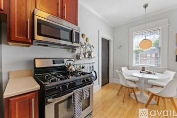 A kitchen with wooden cabinets and a black stove top oven.
