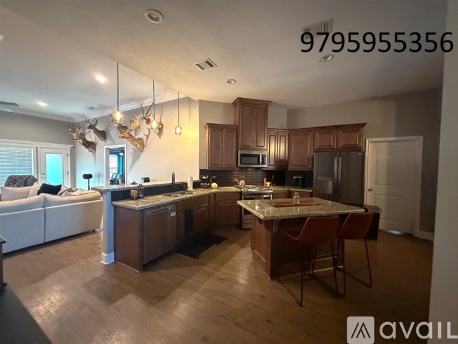 A modern kitchen with wooden cabinets and a central island.