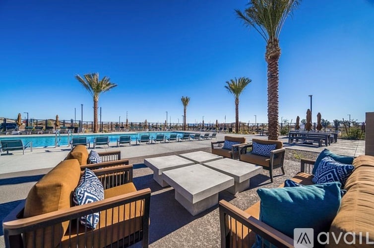 A sunny day at the pool with palm trees and loungers.