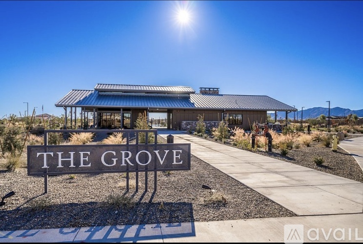 The Grove sign in front of a building with a clear blue sky.