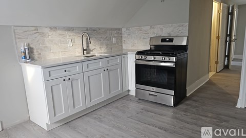A kitchen with a marble backsplash and a stainless steel oven.
