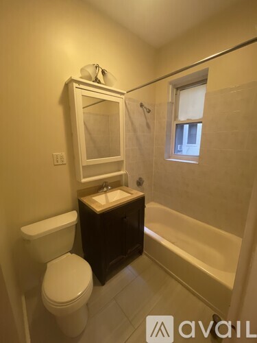 A bathroom with a toilet, sink, and bathtub.