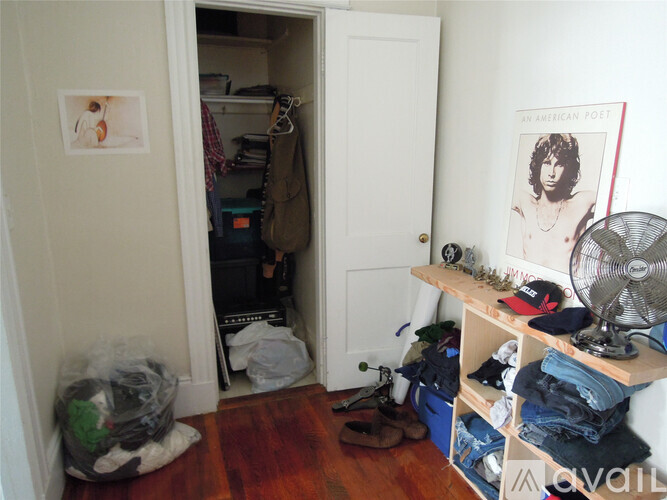 A room with a bookshelf and a poster of an American poet.