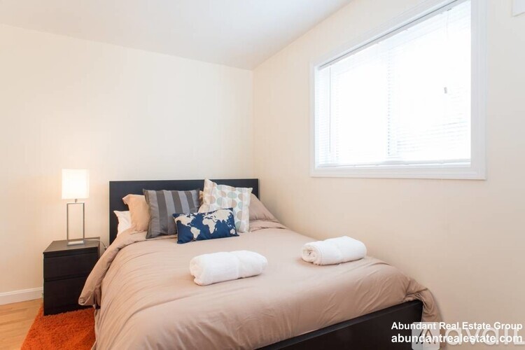 A bedroom with a large bed and a window.