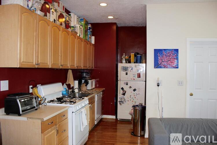 A kitchen with wooden cabinets and a white refrigerator.
