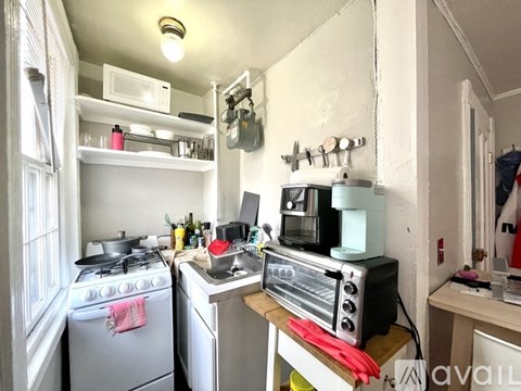 A small kitchen with a stove, oven, and a microwave.