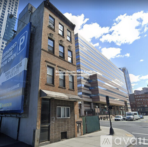 A blue sign on a building advertises a parking garage.