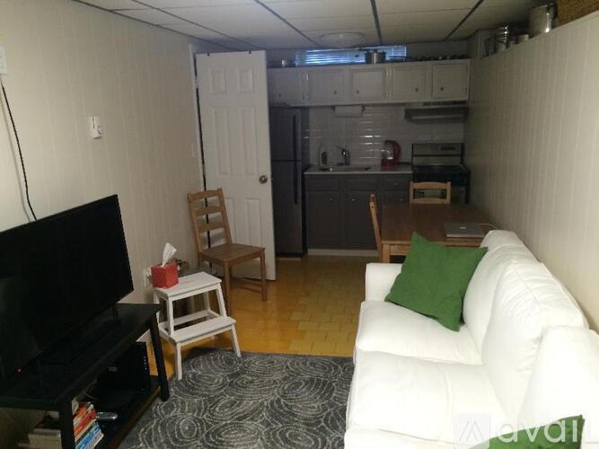 A living room with a white couch and a television.