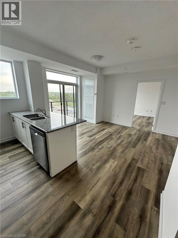 A kitchen with a dishwasher and a refrigerator.