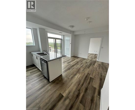 A kitchen with a dishwasher and a refrigerator.