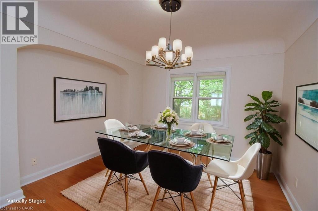 A dining room with a glass table and chairs.