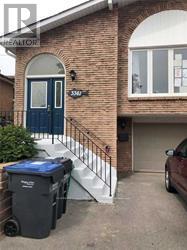 A house with a blue door and a car parked in the driveway.