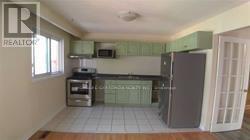 A kitchen with white appliances and a white refrigerator.