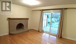 A room with a fireplace and sliding glass doors.