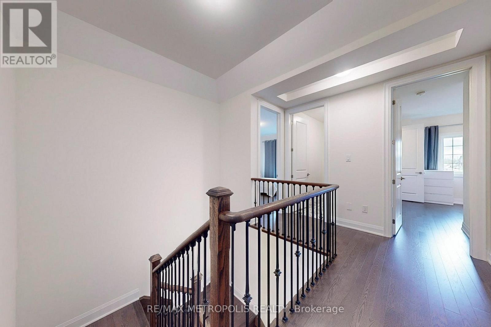 A spacious room with a staircase leading to the upper floor.