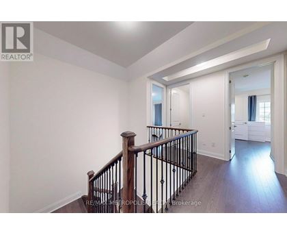A spacious room with a staircase leading to the upper floor.