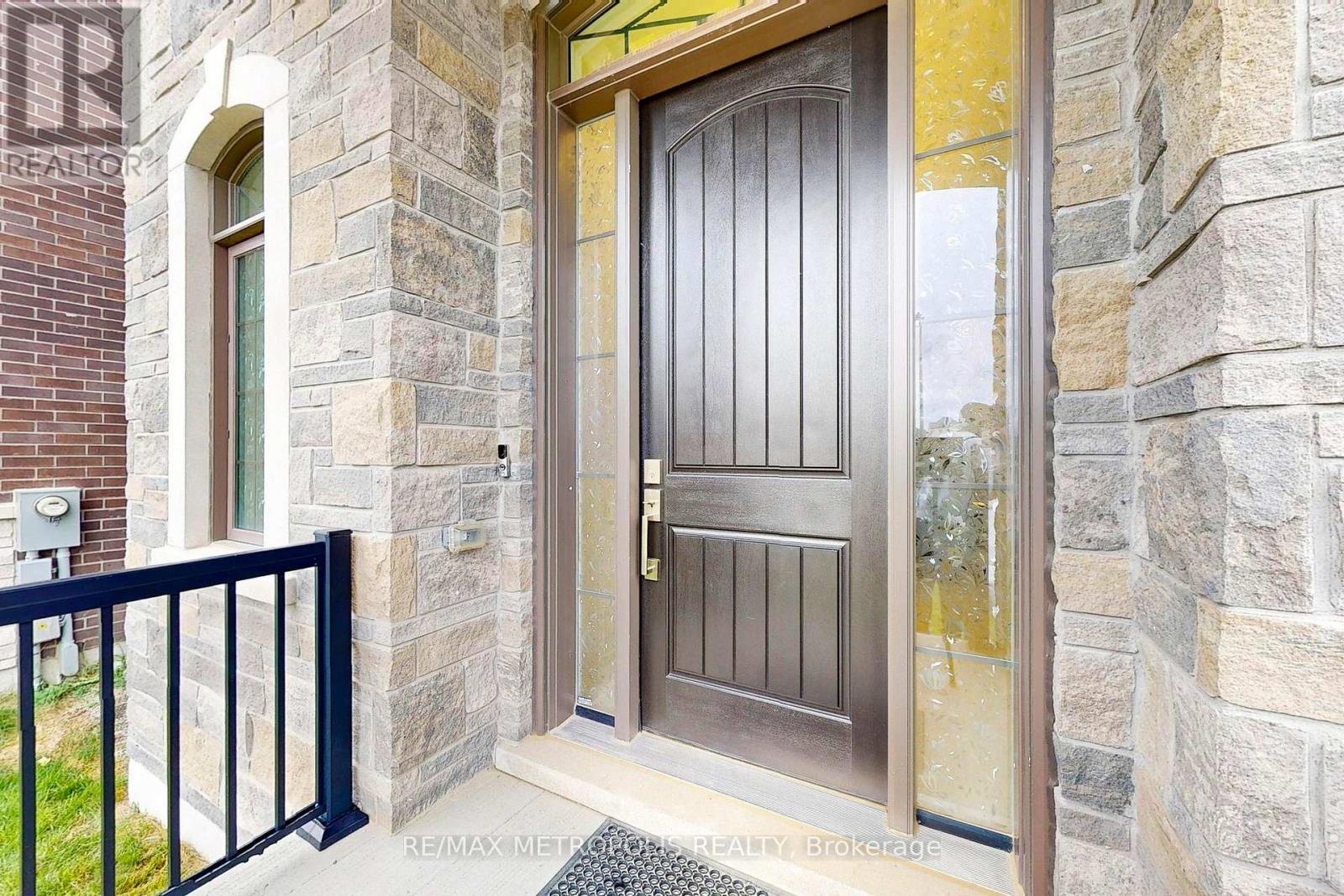 A brown door is on a stone building.
