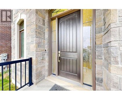 A brown door is on a stone building.