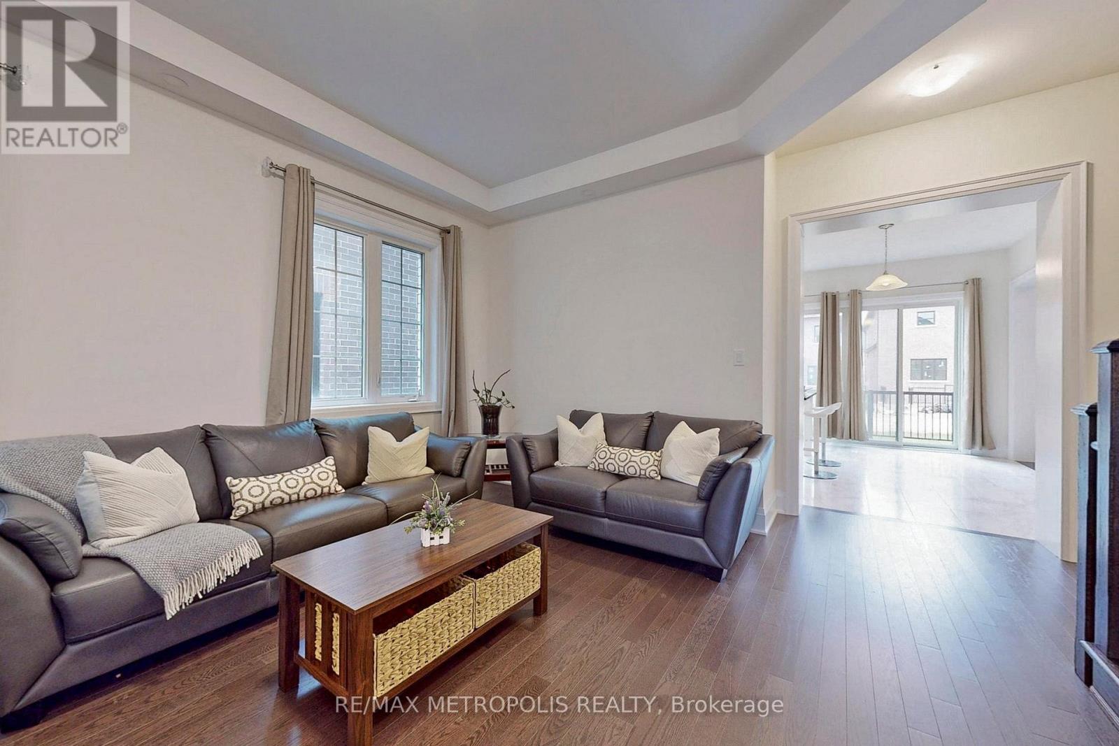A living room with a grey couch and a wooden coffee table.