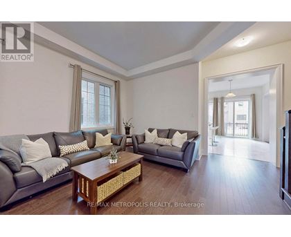 A living room with a grey couch and a wooden coffee table.
