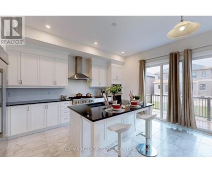 A modern kitchen with white cabinets and a black countertop.