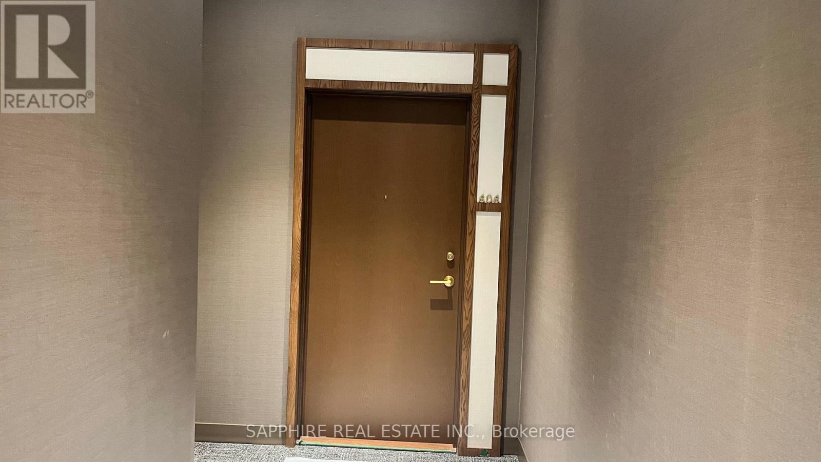 A door in a room with a sign that says "REALTOR".