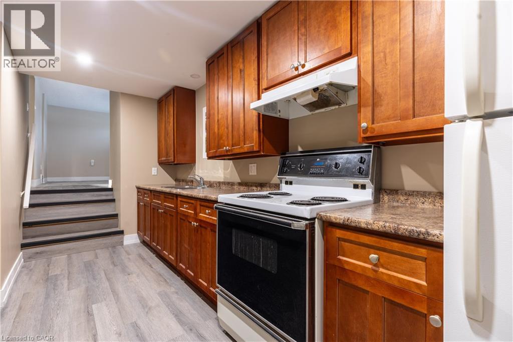 A kitchen with wooden cabinets and a black stove top oven.