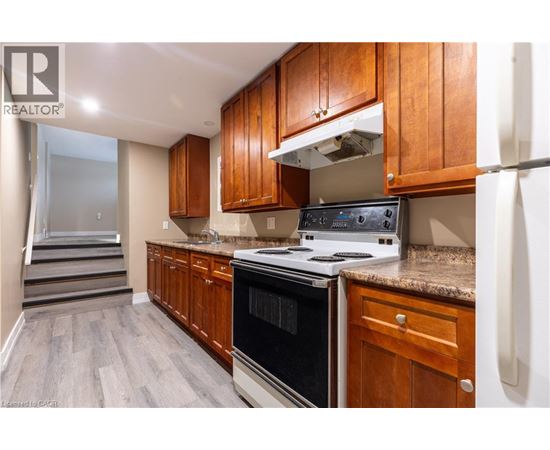 A kitchen with wooden cabinets and a black stove top oven.