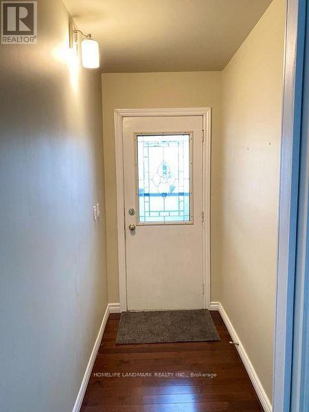 A hallway with a door and a window.