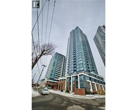 A tall building with many windows is in the foreground of the image.