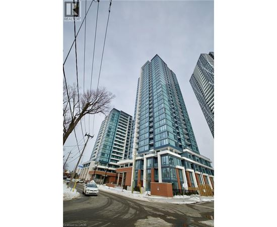 A tall building with many windows is in the foreground of the image.