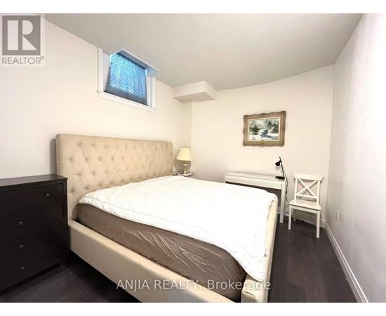 A bedroom with a large bed and a small table.