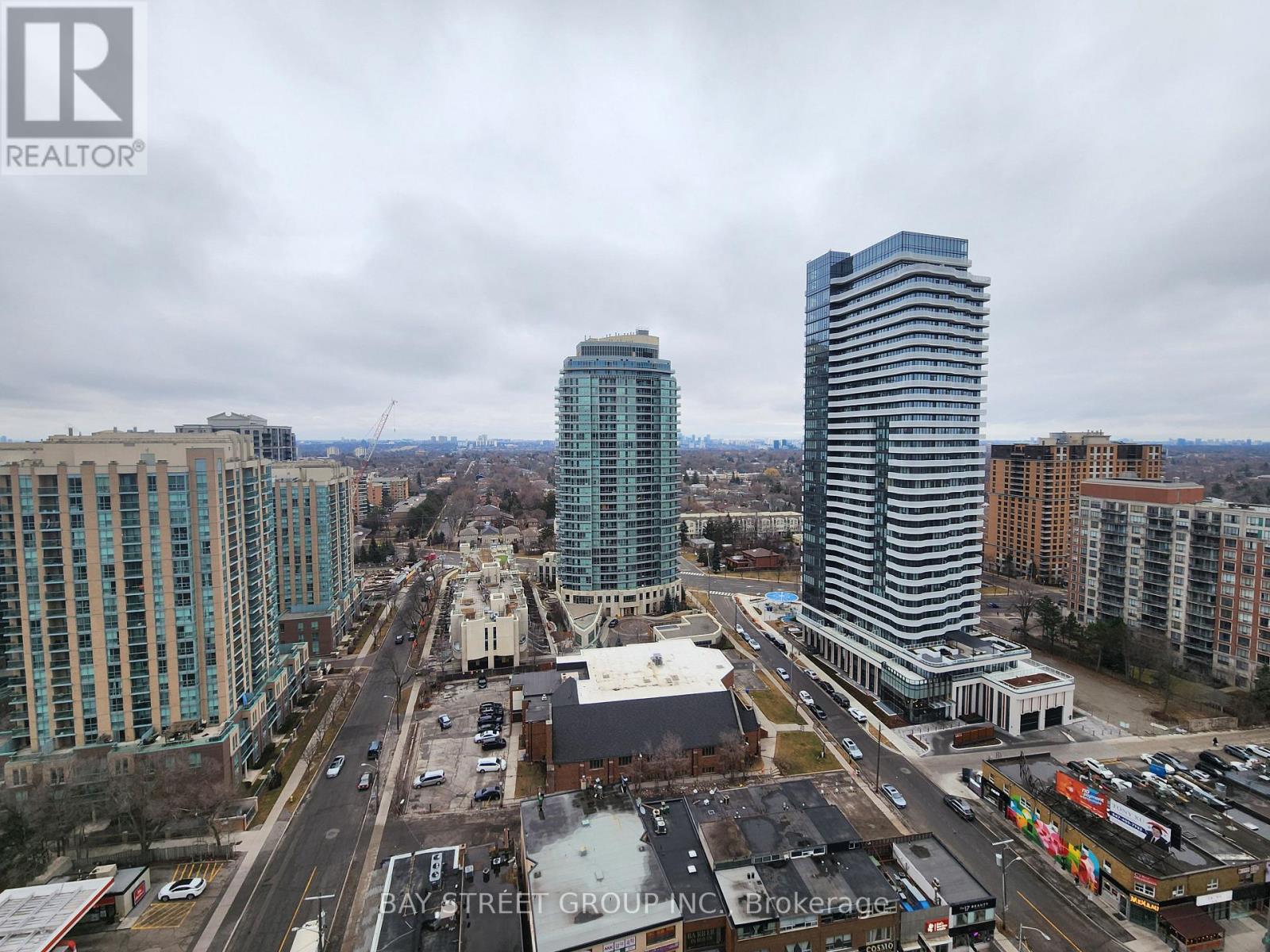 A view of a city street with buildings and cars.